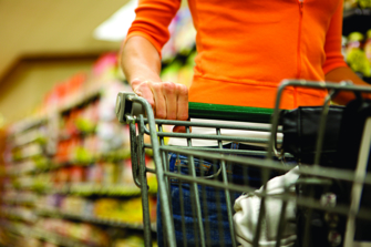 person pushing a supermarket trolley